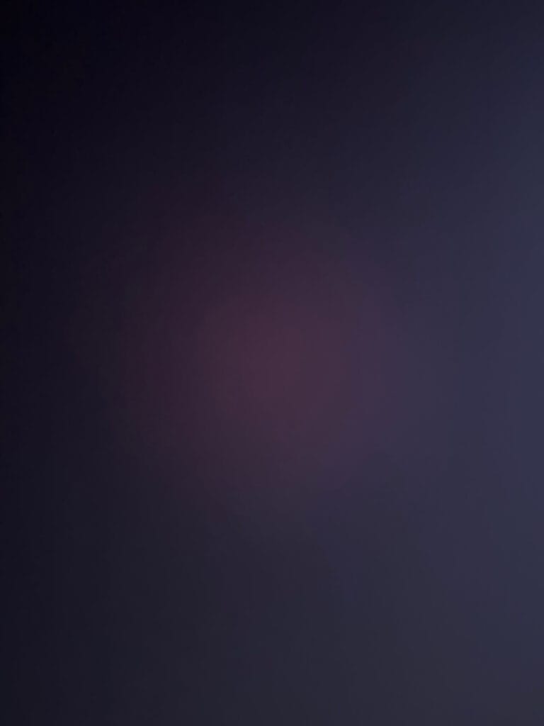 Dark purple gradient background with a subtle pink glow near the bottom-left corner.